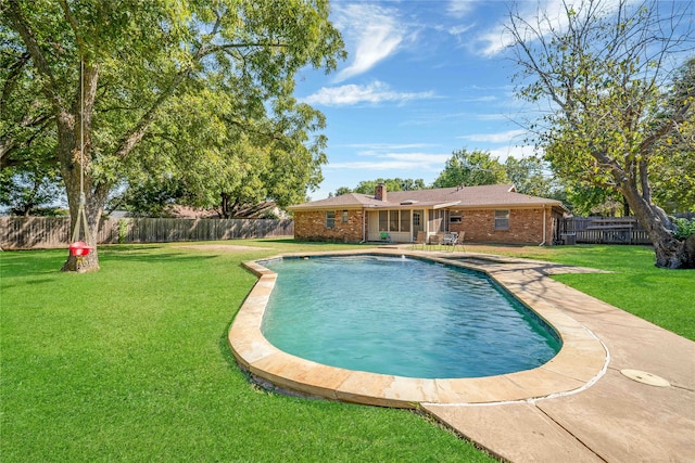 view of pool with a yard and a patio