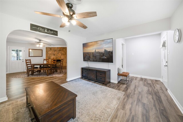 living room featuring ceiling fan and hardwood / wood-style flooring