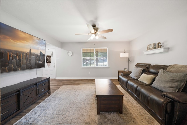 living room featuring dark hardwood / wood-style flooring and ceiling fan