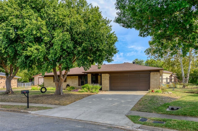 ranch-style home with a front yard and a garage