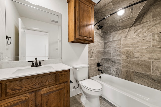 full bathroom with vanity, toilet, and tiled shower / bath