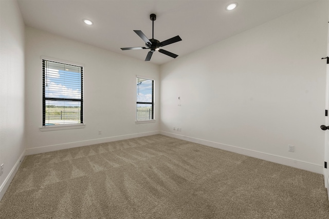 spare room featuring ceiling fan and light colored carpet