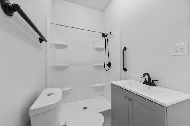 bathroom featuring vanity, toilet, and walk in shower