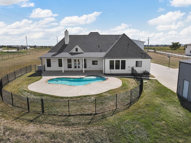 view of swimming pool featuring a patio and a yard