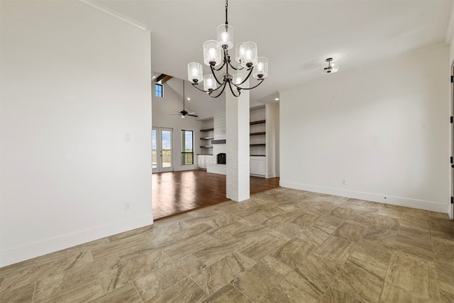 unfurnished dining area with lofted ceiling, ceiling fan with notable chandelier, crown molding, a fireplace, and light hardwood / wood-style floors