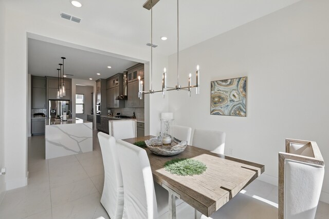 dining room with a chandelier, visible vents, light tile patterned floors, and recessed lighting