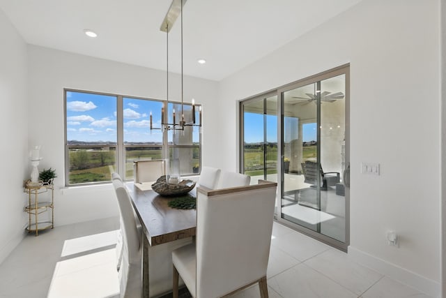 dining room featuring an inviting chandelier, plenty of natural light, recessed lighting, and baseboards