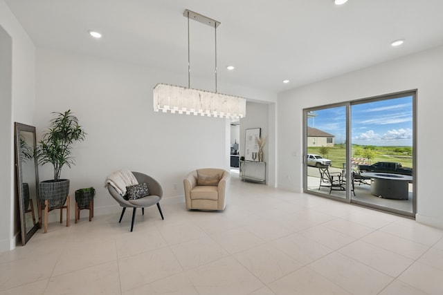 living area featuring light tile patterned floors, recessed lighting, and baseboards