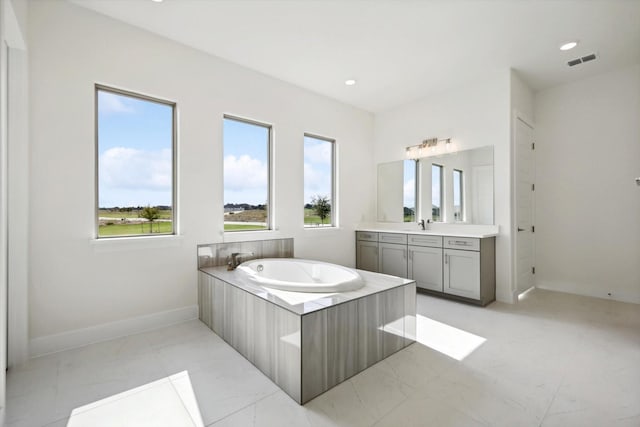 full bathroom with recessed lighting, a bath, vanity, baseboards, and visible vents
