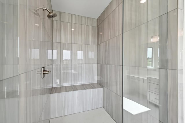 bathroom with a tile shower