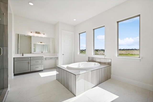 full bath with recessed lighting, a shower stall, a garden tub, and vanity