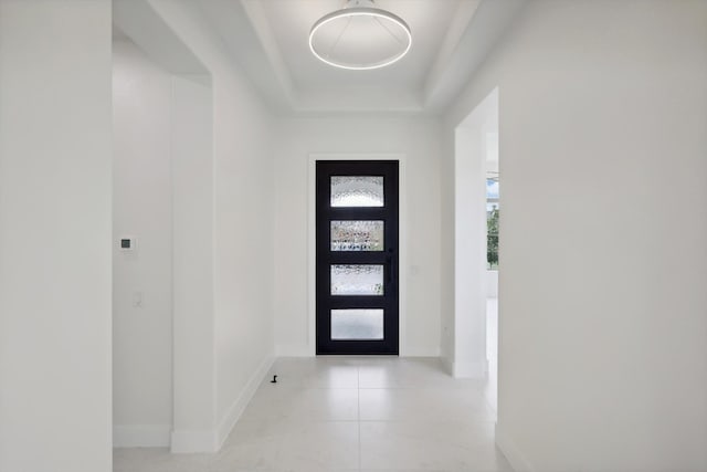 entrance foyer with a tray ceiling