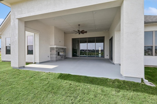 exterior space with a fireplace and a ceiling fan