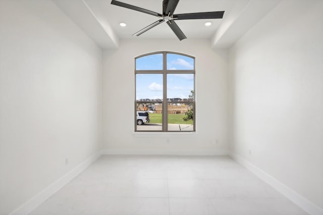 empty room with ceiling fan and a wealth of natural light