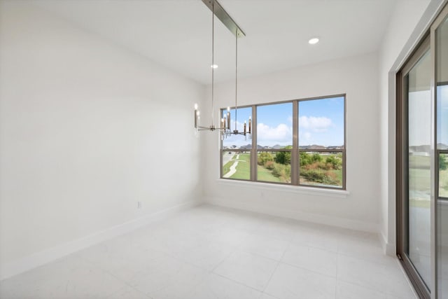 unfurnished dining area with light tile patterned floors, recessed lighting, a notable chandelier, and baseboards