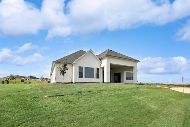 rear view of property featuring a yard