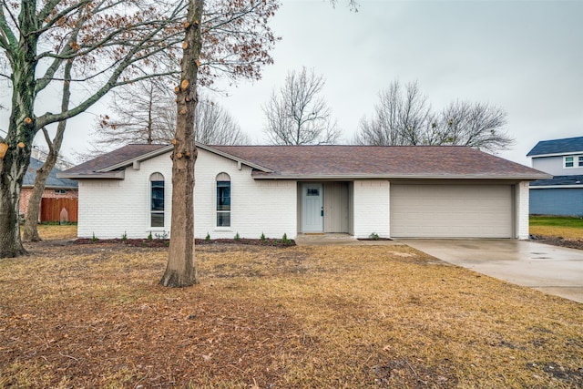 ranch-style home with a garage and a front lawn