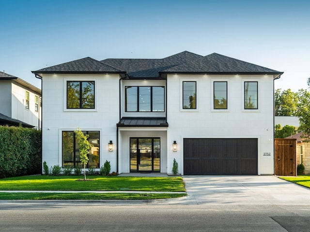 view of front of home with a garage and a front lawn