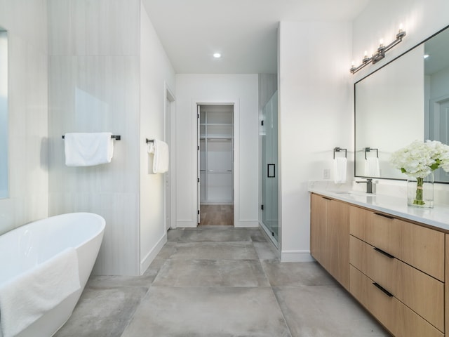 bathroom with vanity, shower with separate bathtub, and concrete floors