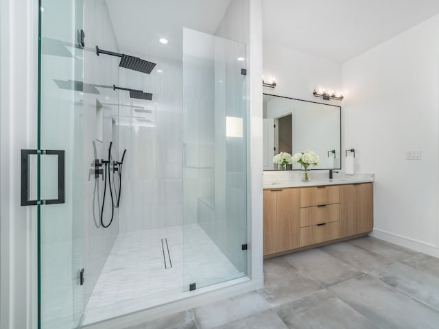 bathroom featuring vanity and a shower with shower door