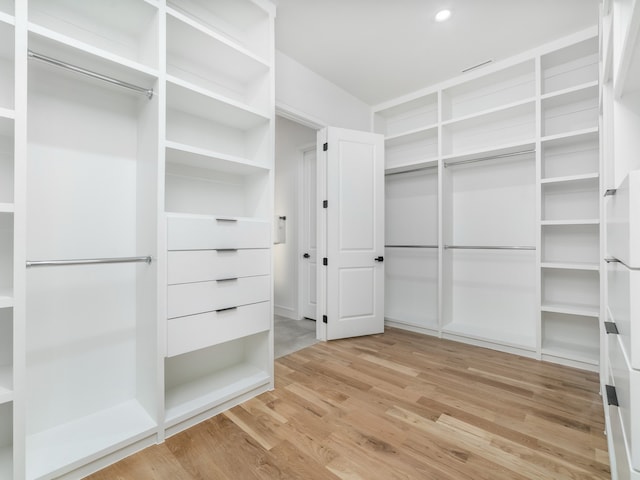 spacious closet with light hardwood / wood-style floors