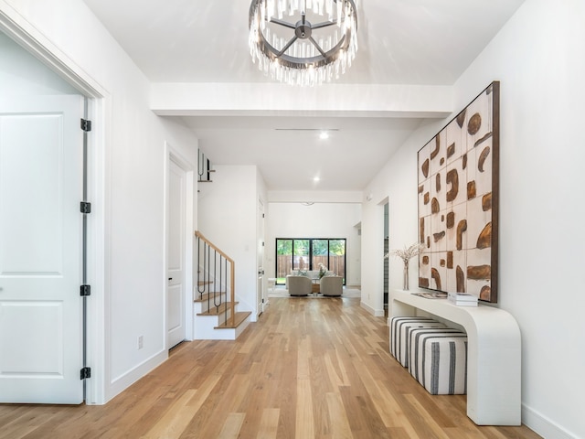 interior space featuring light wood-type flooring and a notable chandelier