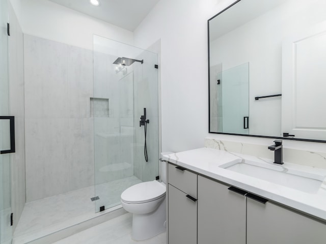 bathroom with vanity, toilet, and walk in shower