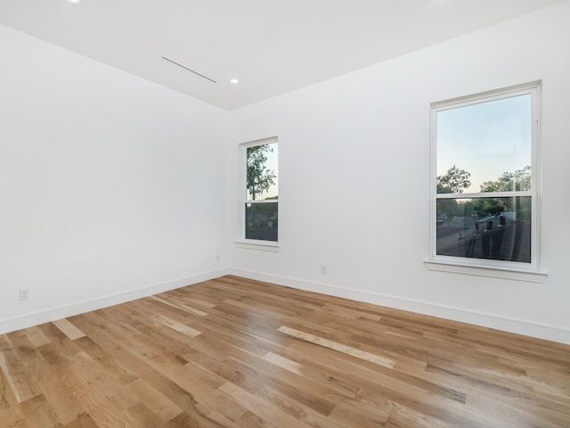 unfurnished room with light wood-type flooring