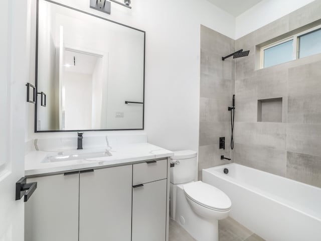 full bathroom featuring vanity, toilet, and tiled shower / bath