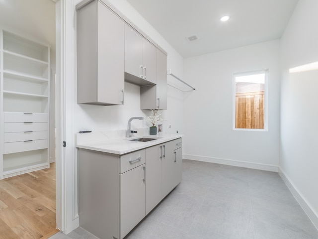 kitchen with sink and light hardwood / wood-style flooring