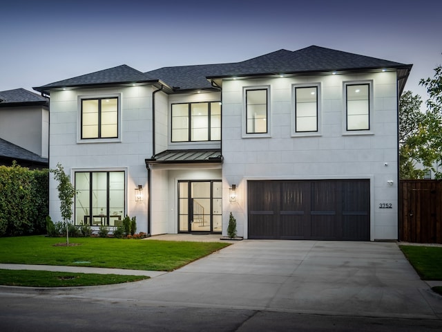 view of front of home featuring a lawn and a garage