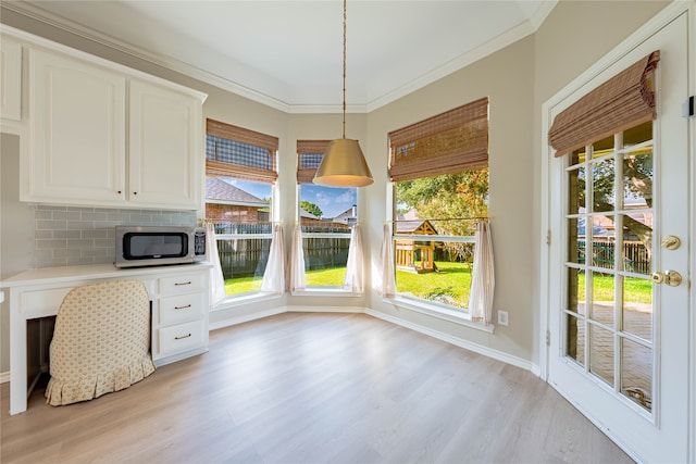 unfurnished dining area with ornamental molding and light hardwood / wood-style floors