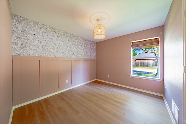 empty room with light hardwood / wood-style floors