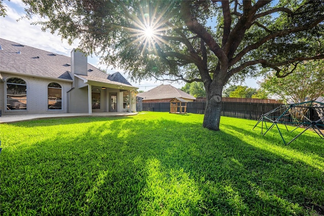 view of yard with a fenced backyard and a patio area