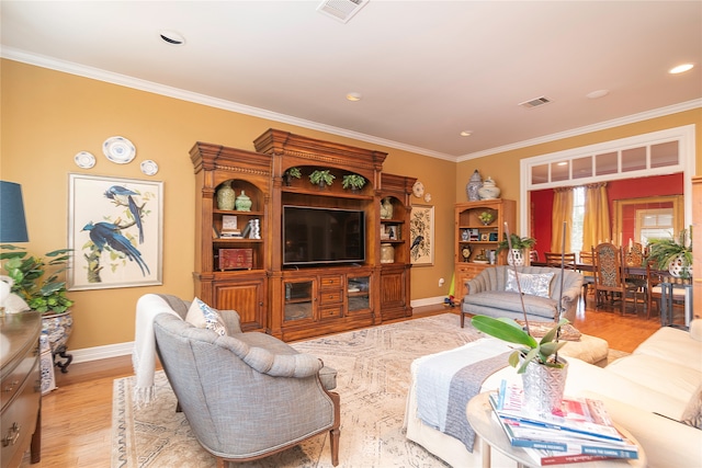 living room featuring crown molding and light hardwood / wood-style flooring