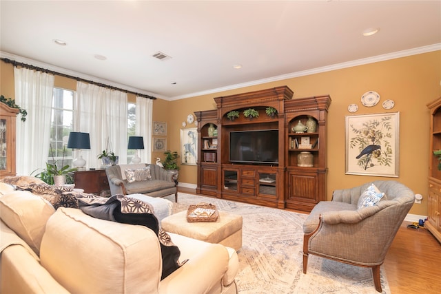 living room with crown molding and light hardwood / wood-style flooring