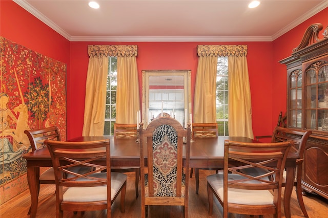 dining room with crown molding, hardwood / wood-style flooring, and a healthy amount of sunlight