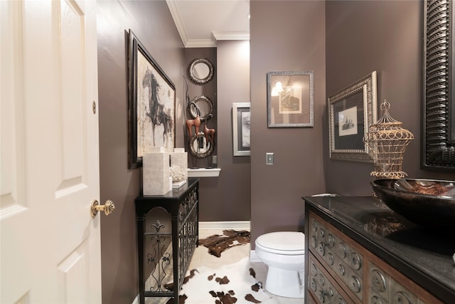 bathroom with ornamental molding, vanity, tile patterned flooring, and toilet