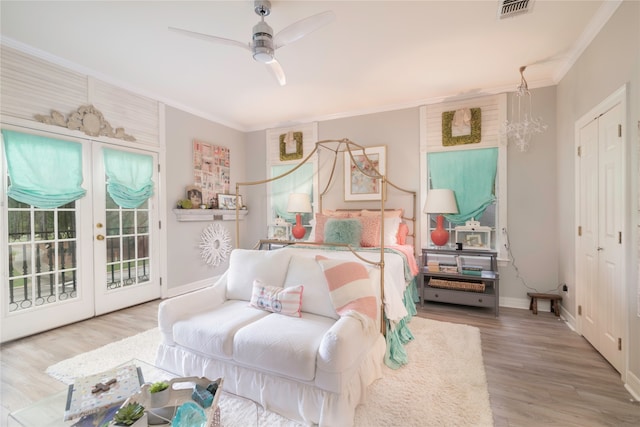 bedroom with ceiling fan with notable chandelier, access to exterior, crown molding, and hardwood / wood-style floors