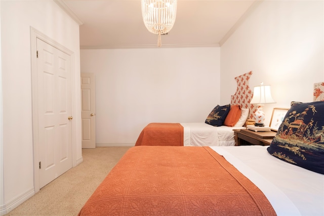 bedroom featuring ornamental molding, a chandelier, and carpet