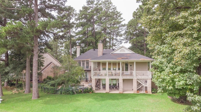 rear view of house with a yard and a patio area