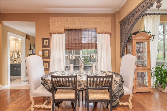 dining area featuring crown molding and wood-type flooring