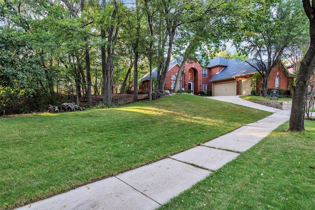 view of front of home featuring a front lawn and a garage