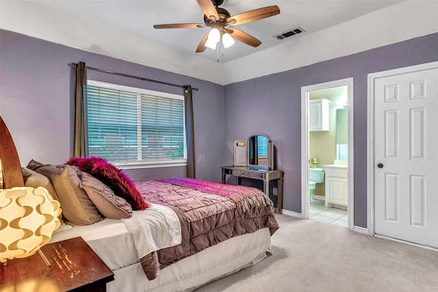 bedroom featuring ensuite bath, ceiling fan, and light carpet