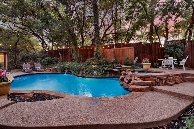 view of pool with a patio area and an in ground hot tub