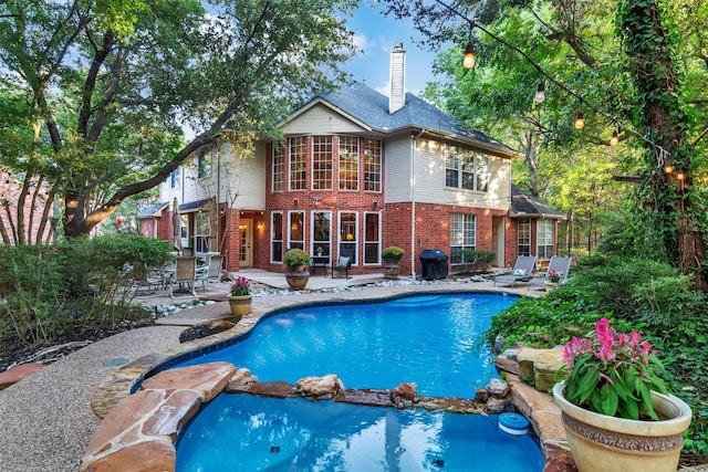 view of swimming pool with a patio and grilling area