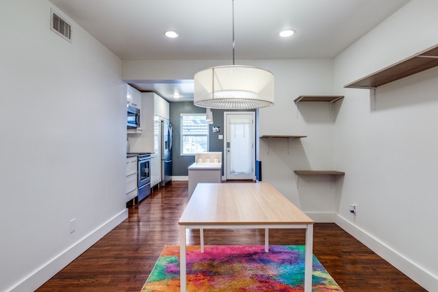 unfurnished dining area with dark hardwood / wood-style floors