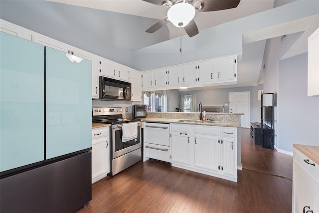 kitchen with dark wood-type flooring, stainless steel range with electric stovetop, white cabinets, and vaulted ceiling