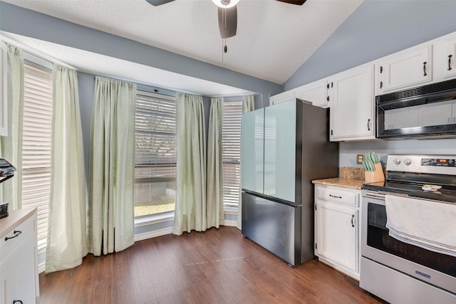 kitchen with ceiling fan, white cabinetry, stainless steel appliances, dark hardwood / wood-style floors, and vaulted ceiling