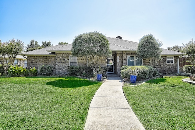 ranch-style home featuring a front yard